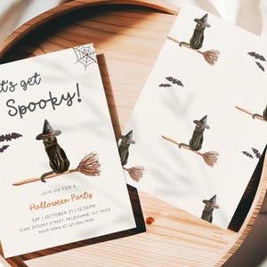 May include: Halloween party invitations featuring a black cat wearing a witch hat and riding a broom. The invitations have the text "Let's get Spooky!" and party details. The design includes bats and a spider web.