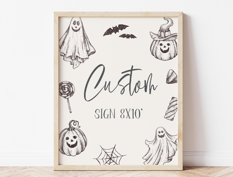 May include: A white sign with a black frame, featuring a custom sign design with the text "Custom Sign 8x10" and various Halloween-themed illustrations, including ghosts, pumpkins, bats, and candy.