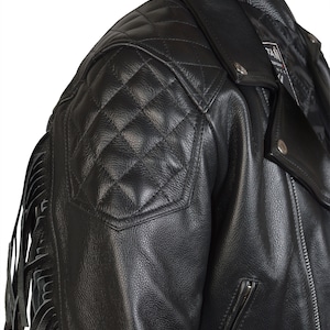 May include: Black leather motorcycle jacket with a quilted design on the shoulders and fringe detail on the sleeves.