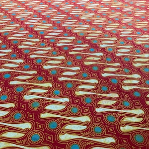 May include: Red fabric with a repeating pattern of white, gold, and teal blue shapes. The design features curved lines, circles, and diamond shapes, creating a visually rich and textured surface.