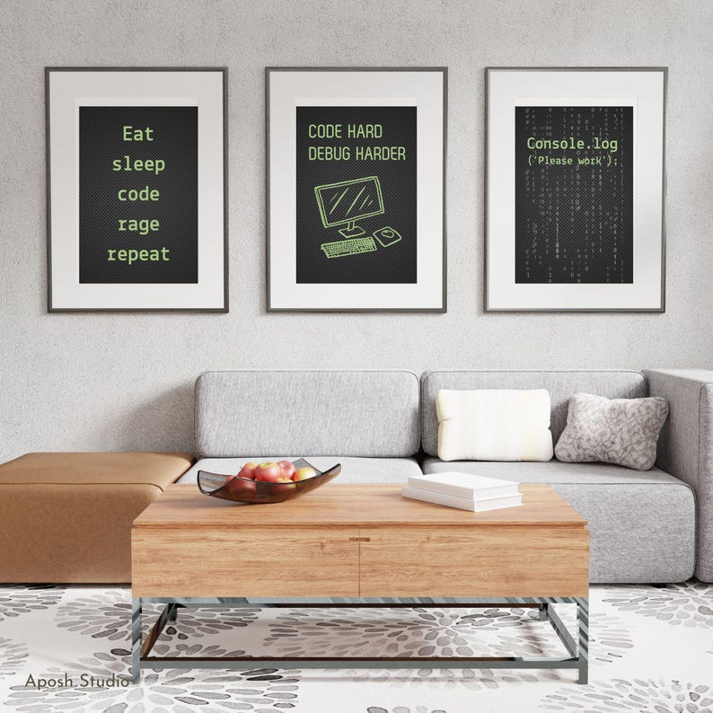 May include: Three framed art prints with black backgrounds and white frames. The prints feature green text and graphics related to coding and programming. One print says "Eat sleep code rage repeat". Another says "Code hard debug harder". The third says "Console.log ('Please work');".