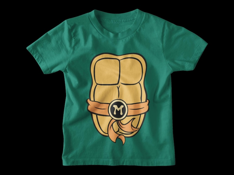 May include: A green t-shirt with a cartoon image of a Teenage Mutant Ninja Turtle's shell. The shell is yellow and orange with a black letter "M" in the center.