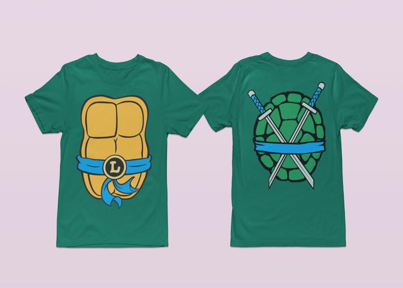 May include: Two green t-shirts with a Teenage Mutant Ninja Turtles theme. One shirt features a yellow and orange turtle shell with a blue bandana and the letter "L". The other shirt features a green turtle shell with two crossed swords and a blue bandana.