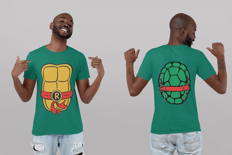 May include: A green t-shirt with a yellow and red turtle shell graphic on the front and a green turtle shell graphic on the back. The turtle shell graphic on the front has a red band with the letter "R" on it.