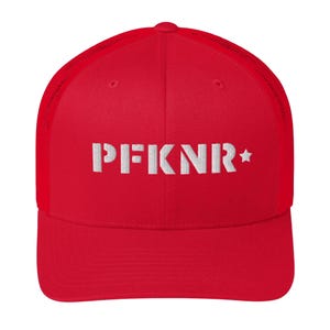 May include: A red trucker hat with a white embroidered design that reads "PFKNR" and a white star. The hat has a mesh back and a curved brim. The hat is a baseball cap style.