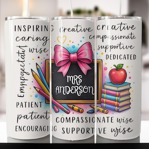 May include: A white tumbler featuring a design for a teacher. The design includes a pink bow, a chalkboard with "Mrs. Anderson" written on it, pencils, crayons, an apple, and books. The tumbler also has words like "inspiring" and "creative".
