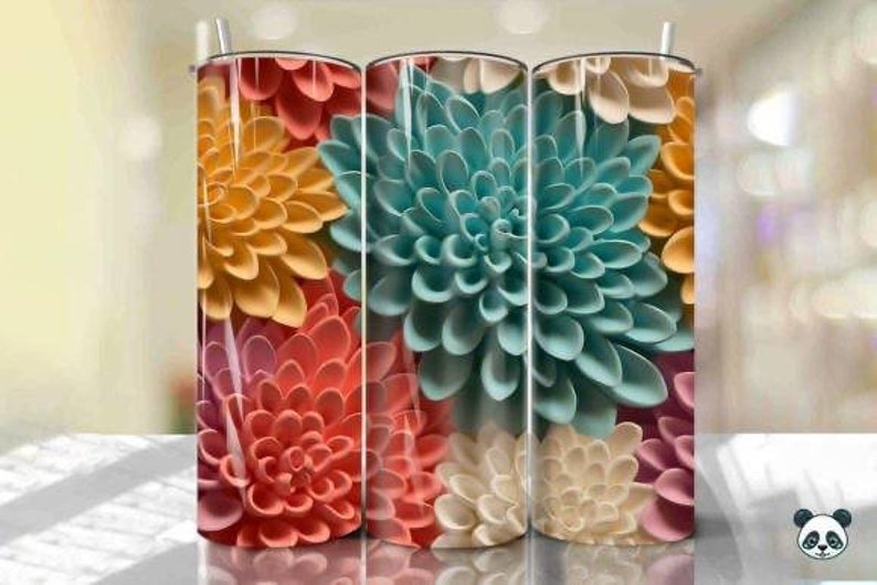 May include: Three stainless steel tumblers with a floral design. The tumblers feature a close-up of colorful paper flowers in shades of pink, yellow, blue, and white.