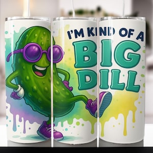 May include: A white tumbler featuring a cartoon pickle wearing purple sunglasses and sneakers. The text "I'M KIND OF A BIG DILL" is displayed in teal and white. The design includes watercolor-style drips.