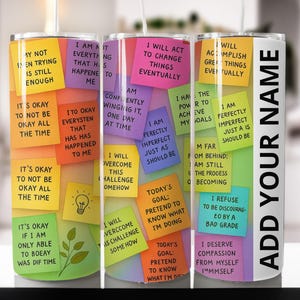 May include: A stainless steel tumbler with a white background and colorful sticky notes. The notes have motivational phrases like "I am perfectly imperfect" and "I will accomplish great things." The right side has the text "ADD YOUR NAME".