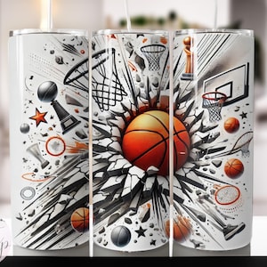 May include: A white tumbler with a basketball theme design. The design features a basketball breaking through a wall with basketballs, hoops, and trophies scattered around it.