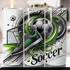 May include: White tumbler featuring a soccer theme. The design includes a soccer ball, a soccer cleat with green accents, and the word "Soccer" in a stylized font. The background has green and black abstract elements.