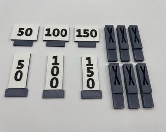 May include: A set of 10 game pieces for a board game. The pieces are made of white plastic with black numbers and letters. The numbers are 50, 100, 150, and the letters are 'X'.