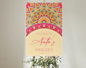 May include: A welcome sign for a Sangeet celebration with a colorful mandala design. The sign says "Welcome to Arita's Sangeet, September 8, 2023".