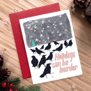 Carte de vœux originale et irrévérencieuse – Carte de Noël Le meurtre des corbeaux avec bonnet de Noel, enveloppe rouge et autocollant « Santa Caws »