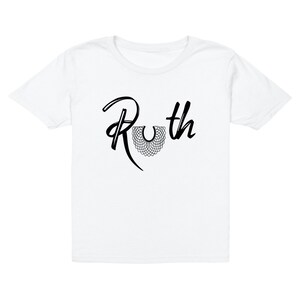 May include: White t-shirt with a black graphic of the name "Ruth" with a stylized black collar design.