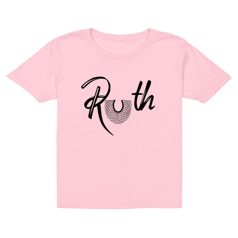 May include: Pink children's t-shirt with a black graphic of the text "Ruth" with a stylized black collar design.