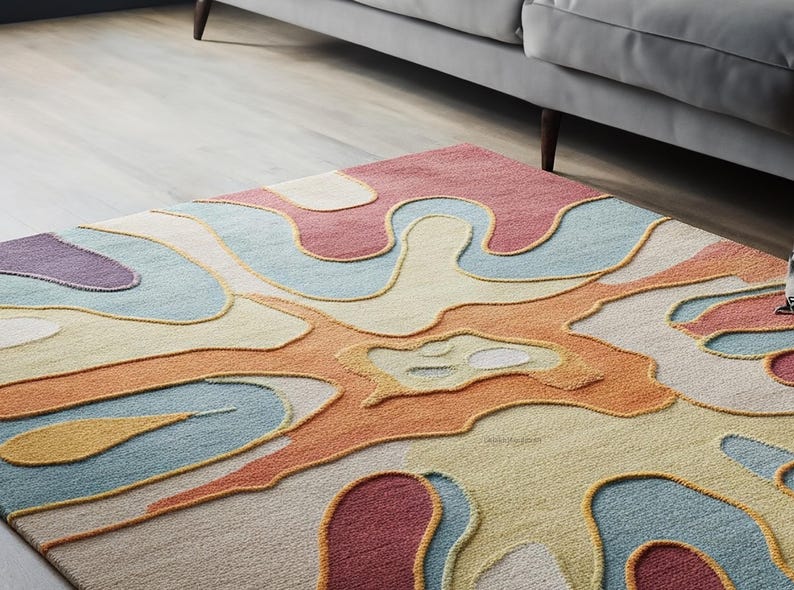 Pu&ograve; includere: Tappeto d'area astratto con un design ondulato colorato in tonalit&agrave; di blu, arancione, rosa e giallo. Il tappeto ha un effetto testurizzato 3D.