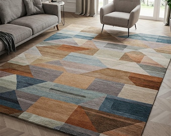 May include: A geometric patterned rug with a mix of brown, blue, and beige tones. The rug has a modern design with a variety of shapes and sizes.