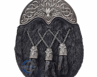 May include: Black kilt sporran with a silver stag head and Celtic knot design. The sporran has three tassels with stag head embellishments.