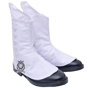 May include: A pair of white boots with black leather soles. The boots have a tall, button-up design on the front and a decorative logo on the side. The soles have a perforated design.