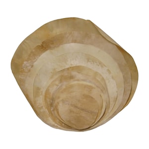 May include: A set of round, beige leather pieces stacked on top of each other, creating a layered, bowl-like shape.