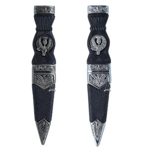 May include: Two black and silver sgian-dubh knives. The sheaths are black with silver thistle emblems and decorative silver bands. The blades are silver and pointed. The handles are black with silver detailing.