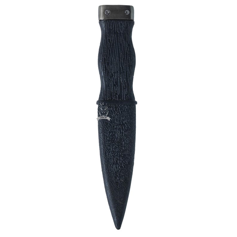 May include: A black dagger with a textured handle and a metal cap. The dagger has a pointed blade and a decorative band near the handle. The handle has a wood-like texture.