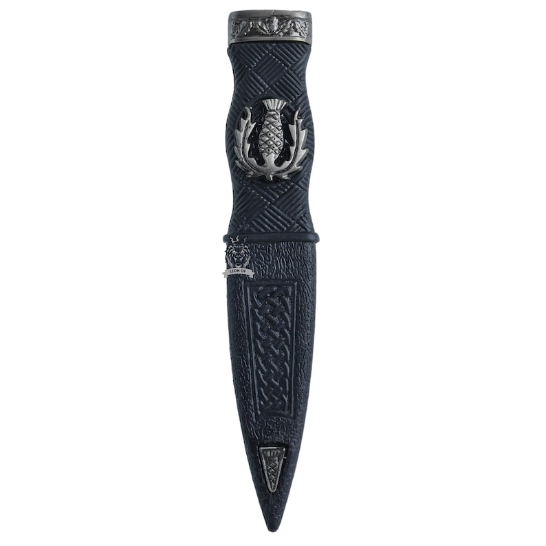 May include: A black dagger sheath with a silver thistle emblem. The sheath has a textured pattern and a decorative silver band at the top. The bottom of the sheath has a pointed tip with a silver emblem.