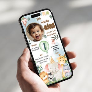 May include: A blue and green mobile phone screen with a birthday invitation for a baby boy turning one year old. The invitation features a photo of the baby, a green balloon with the number one, and a jungle animal theme with a lion, zebra, elephant, giraffe, and hippo. The text on the invitation reads "Ich werde eins...und du bist eingeladen!"  "Wann? am Samstag 15.09.2025" "Wo? BEI UNS ZU HAUSE Wilhelmstra&szlig;e 134, 10234 Berlin" "Ich kann es kaum erwarten dich zu sehen! Dein Leo"