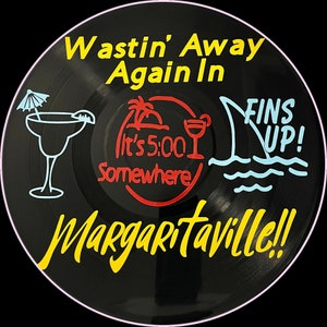 May include: A black vinyl record with a yellow and red design. The text on the record reads 