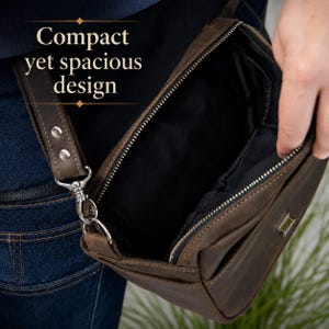 May include: A brown leather crossbody bag with a zippered opening, black interior lining, and a metal attachment point for the strap. The bag features the text Compact yet spacious design printed in white on the upper left side of the image.