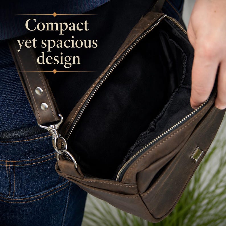May include: A brown leather crossbody bag with a zippered opening, black interior lining, and a metal attachment point for the strap. The bag features the text Compact yet spacious design printed in white on the upper left side of the image.