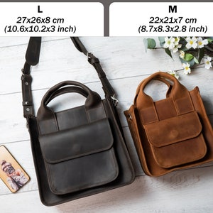 May include: Two leather tote bags, one brown and one black, with adjustable straps. The brown bag is labelled "M 22x21x7 cm (8.7x8.3x2.8 inch)" and the black bag is labelled "L 27x26x8 cm (10.6x10.2x3 inch)".