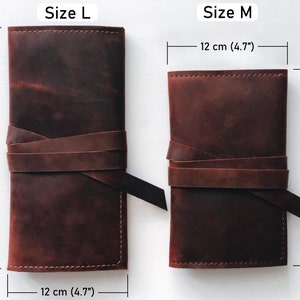 May include: Two brown leather pouches with a strap closure. The larger pouch measures 9.4 inches by 4.7 inches. The smaller pouch measures 7.7 inches by 4.7 inches. Size L and Size M are labeled on the pouches.