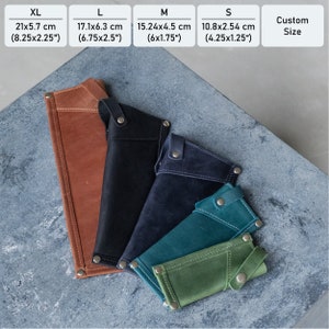 May include: Five leather pouches in different sizes and colors, ranging from XL to S. The pouches are made of brown, black, dark blue, teal, and green leather. The pouches are laid out on a gray textured surface. The measurements for each size are listed above the pouches in inches and centimeters.