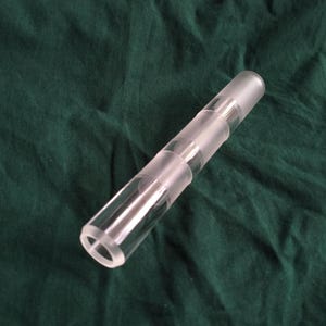 May include: A clear glass tube with a frosted finish. The tube is approximately 15 inches long and has a diameter of 1 inch.