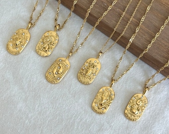 May include: Seven gold necklaces with zodiac signs on oval pendants. Each pendant features a different zodiac sign and is decorated with small clear rhinestones. The necklaces are displayed on a wooden surface.