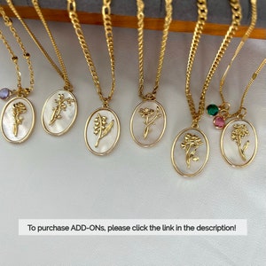 May include: Six gold-tone necklaces featuring oval pendants with white mother-of-pearl inlays and embossed floral designs. Some pendants include small colored crystal charms. The text "To purchase ADD-ONs, please click the link in the description!" is visible.