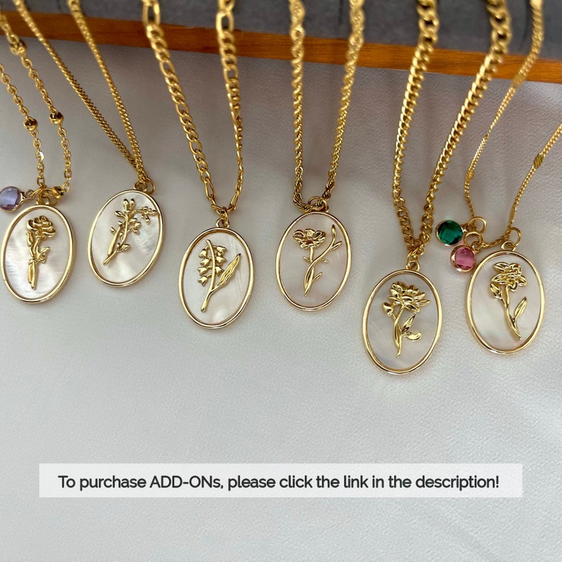 May include: Six gold-tone necklaces featuring oval pendants with white mother-of-pearl inlays and embossed floral designs. Some pendants include small colored crystal charms. The text "To purchase ADD-ONs, please click the link in the description!" is visible.