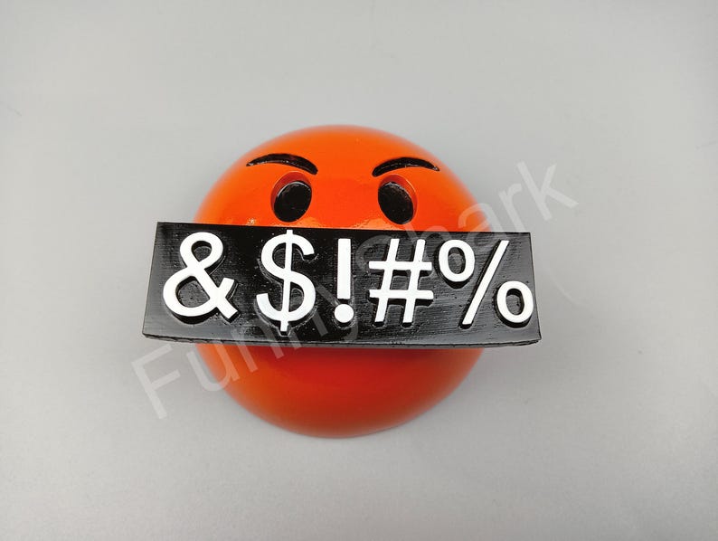 May include: An orange emoji with angry eyebrows and black eyes, a black rectangle covers the mouth with white symbols: & $ ! # %. The emoji is a sphere shape.