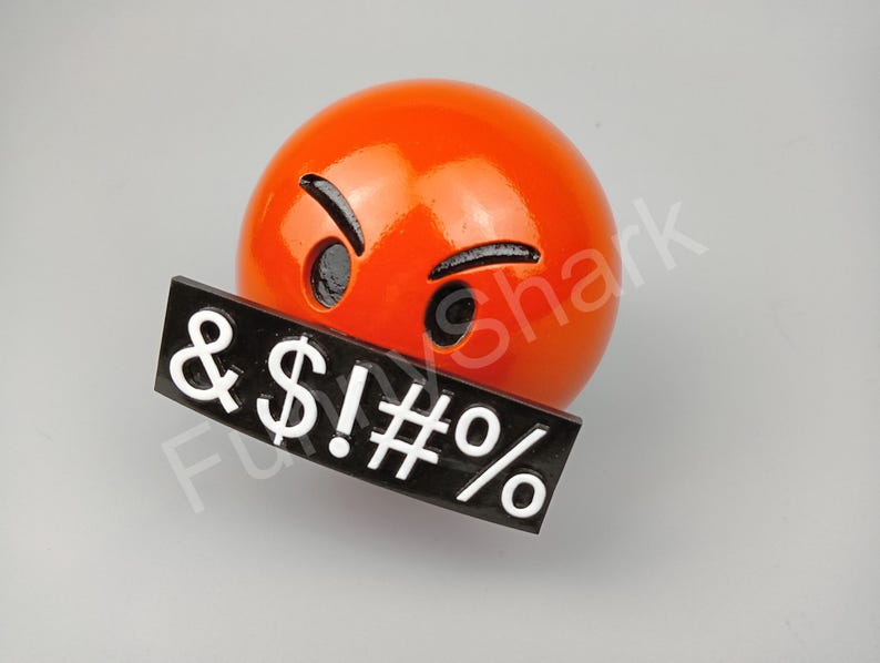 May include: A bright orange emoji with angry eyes and eyebrows, and a black sign with white symbols: & $ ! # %.