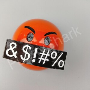 May include: An orange emoji with angry eyebrows and eyes, and a black rectangle covering the mouth with white symbols: & $ ! # %.