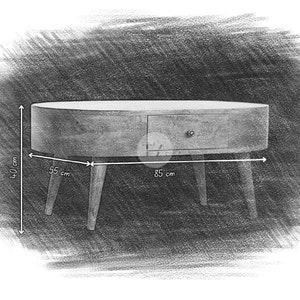May include: A wooden oval coffee table with a single drawer and three legs. The table is 55 inches wide, 40 inches tall, and 85 inches long.