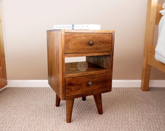 May include: A wooden bedside table with two drawers and a shelf. The table has a dark brown finish and stands on four legs.