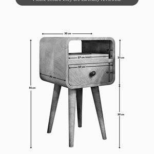 May include: A light wood bedside table with a drawer and a shelf. The table is 25 inches tall, 30 inches wide, and 10 inches deep. The drawer is 27 inches wide and 10 inches deep. The shelf is 27 inches wide and 10 inches deep.