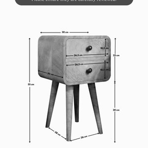 May include: A wooden bedside table with two drawers and four legs. The table is 76 cm wide, 63.5 cm tall, and 66 cm deep. The drawers are 26.5 cm wide and 67.5 cm deep.