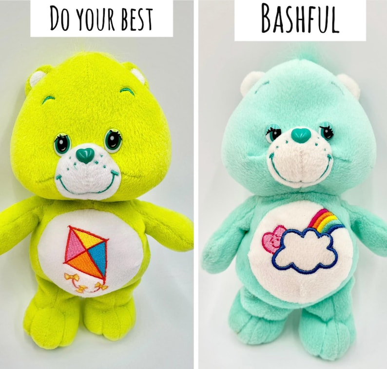 May include: Two plush bear toys. The left bear is lime green with a kite graphic on its belly and the text DO YOUR BEST above it. The right bear is mint green with a cloud and rainbow graphic on its belly and the text BASHFUL above it.