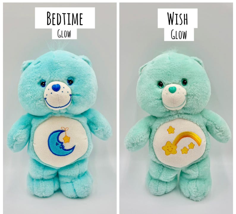 May include: Two plush bear toys with soft fur. The left bear is bright blue with a blue crescent moon and yellow star emblem, labeled BEDTIME GLOW. The right bear is mint green with a yellow rainbow and star emblem, labeled WISH GLOW.