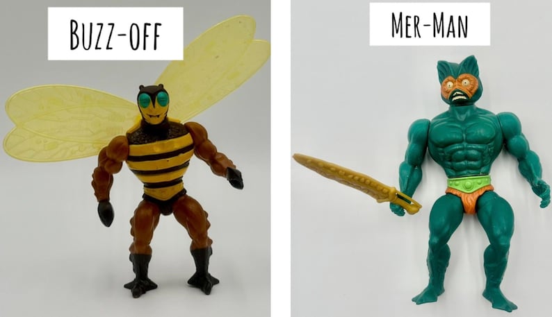 May include: Two action figures: "Buzz-Off," a bee-themed character with yellow wings and striped torso, and "Mer-Man," a teal-colored humanoid with a sword. The figures are posed against a white background.