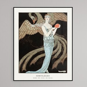 May include: Art Deco print featuring a woman in a flowing blue gown, holding a red orb, with a large phoenix behind her. The print has a black background and the text "SORTIL&Egrave;GES" and "ROBE DU SOIR, DE BEER".